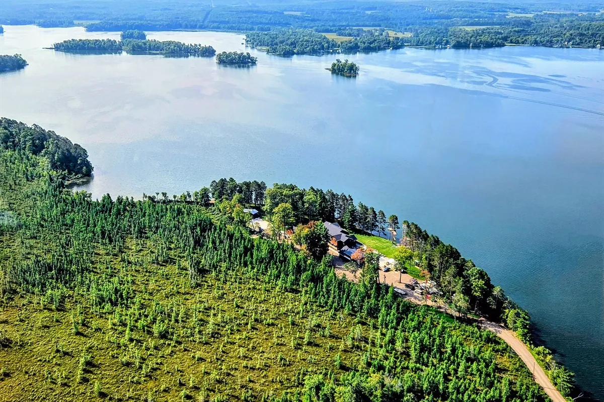 Aerial view of The Island lodge in Spooner, Wisconsin with the lake behind it