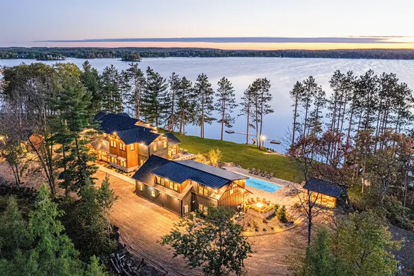 The Island lodge in Spooner, Wisconsin at sunset, lake behind it and lights lit up